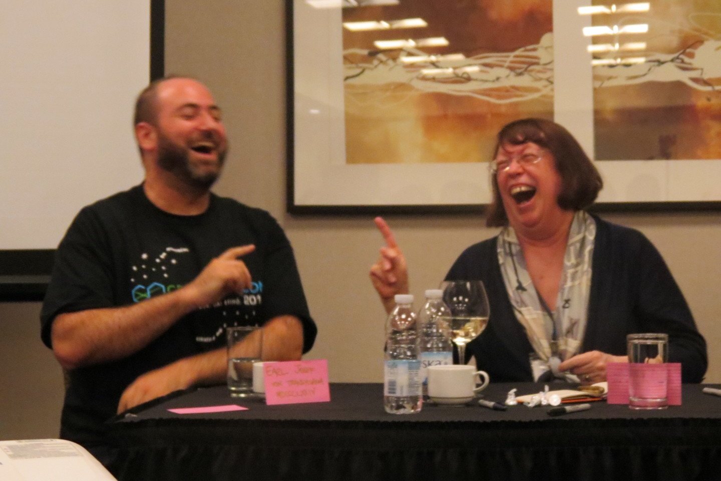 Diane and Eli laughing during a panel